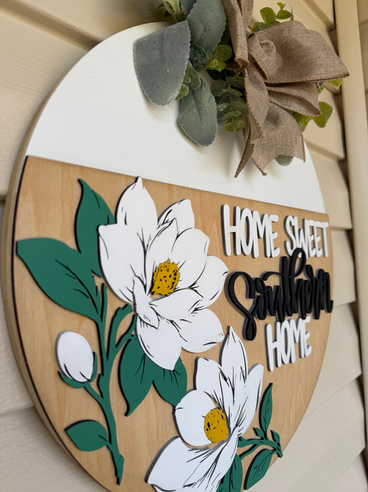 Decorative sign with flowers and text on a wooden background