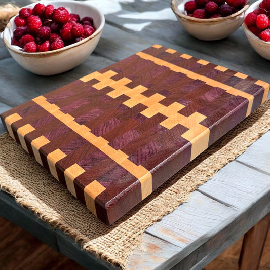 Purple rain cutting board by Covered Bridge Workshop, made of durable wood with a smooth surface and vibrant purple finish.