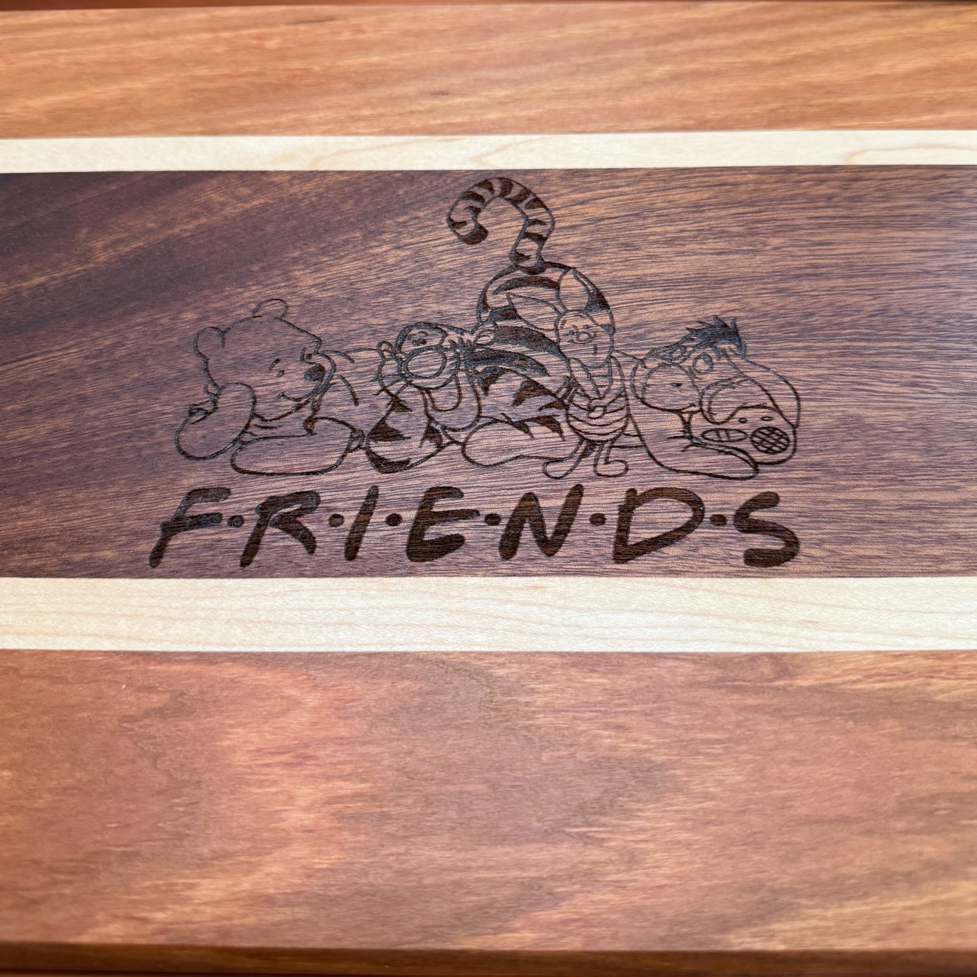 Decorative Pooh & Friends serving tray by Covered Bridge Workshop with colorful character illustrations on a wooden surface.