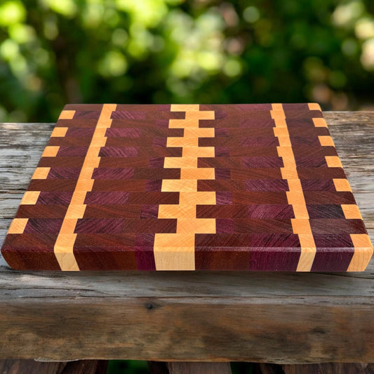 Purple Rain cutting board by Covered Bridge Workshop, showcasing a vibrant purple wooden surface with a smooth finish.