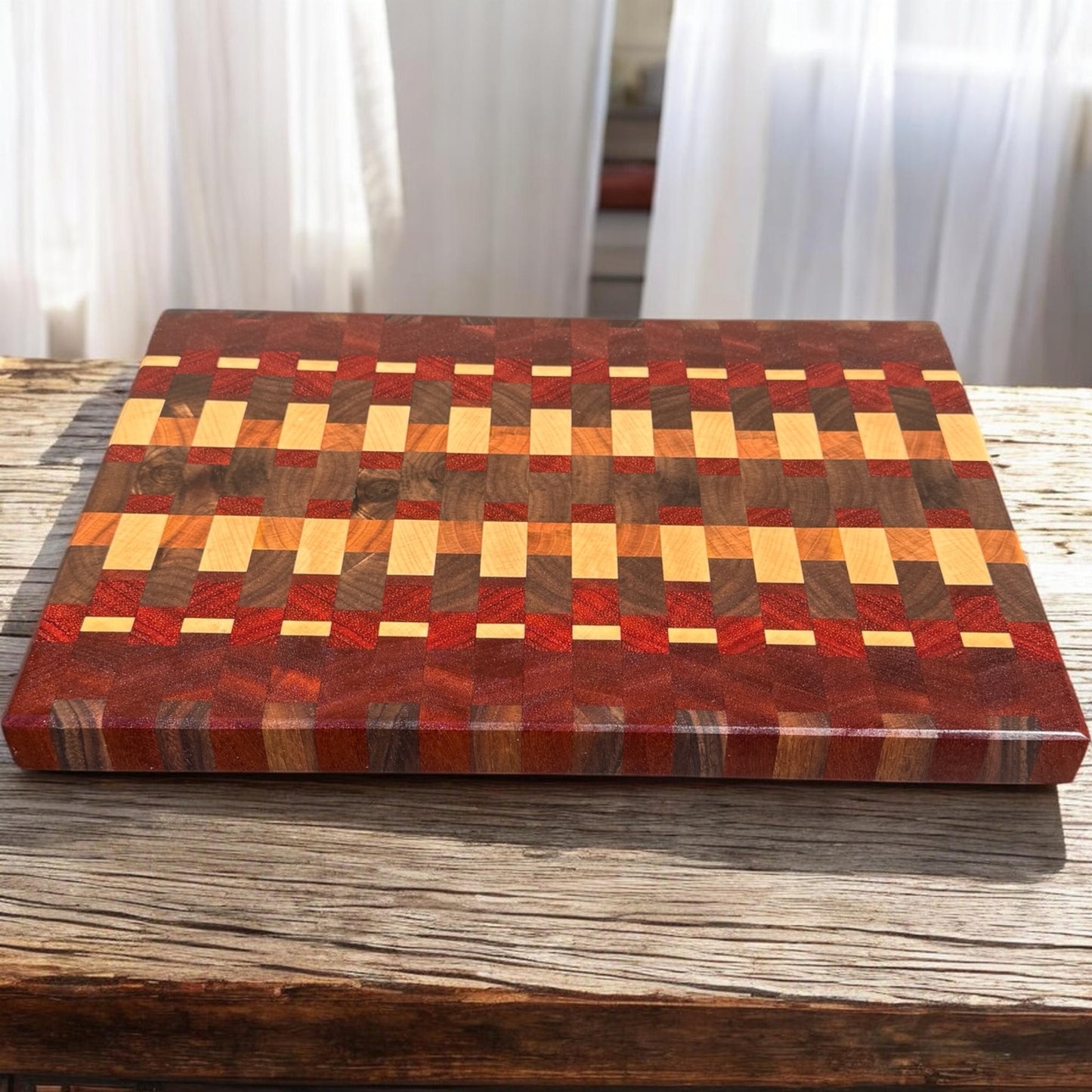 Wooden cutting board with Tequila Sunrise design from Covered Bridge Workshop, featuring vibrant sunrise artwork on a sturdy surface.