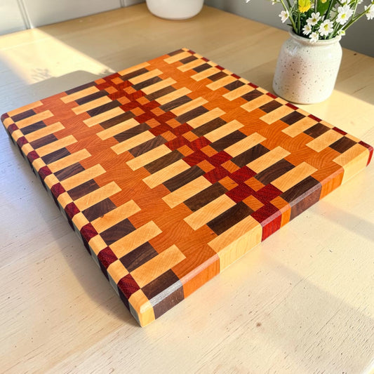 Wooden cutting board with "Dream On" engraved design from Covered Bridge Workshop, ideal for kitchen prep and serving.