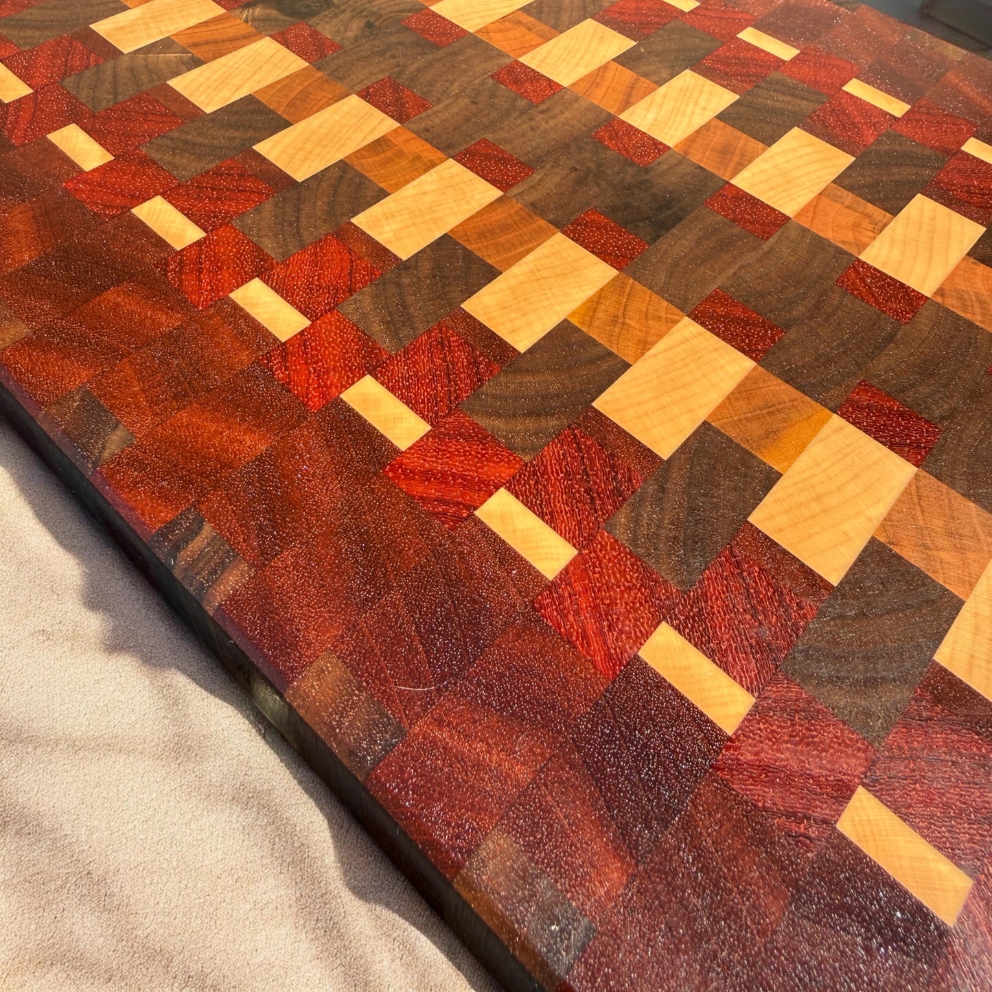 Wooden cutting board with Tequila Sunrise design by Covered Bridge Workshop, featuring vibrant, colorful artwork on a smooth surface.