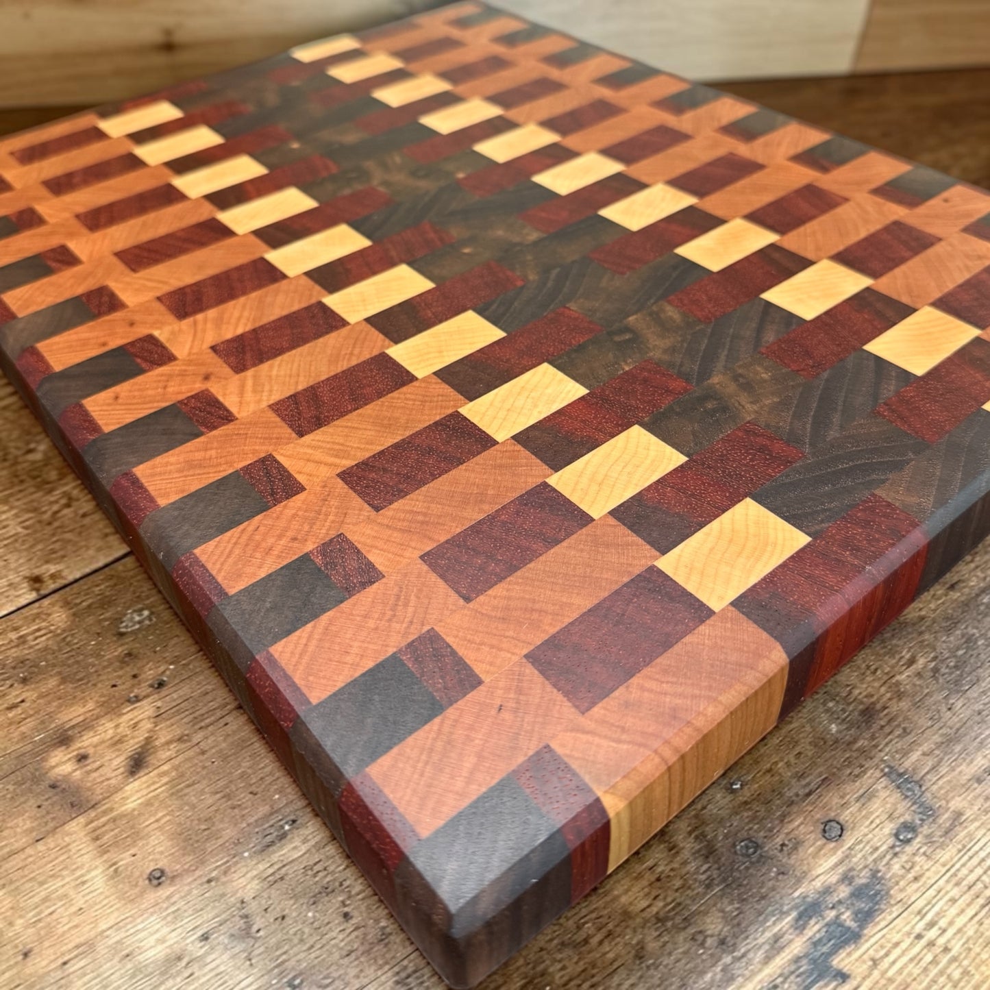 Wooden cutting board from Covered Bridge Workshop with a smooth surface and natural wood grain, ideal for food preparation.