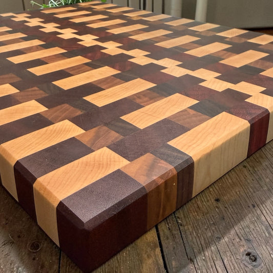 Covered Bridge Workshop Happy Together cutting board with colorful, engraved design on smooth wooden surface.