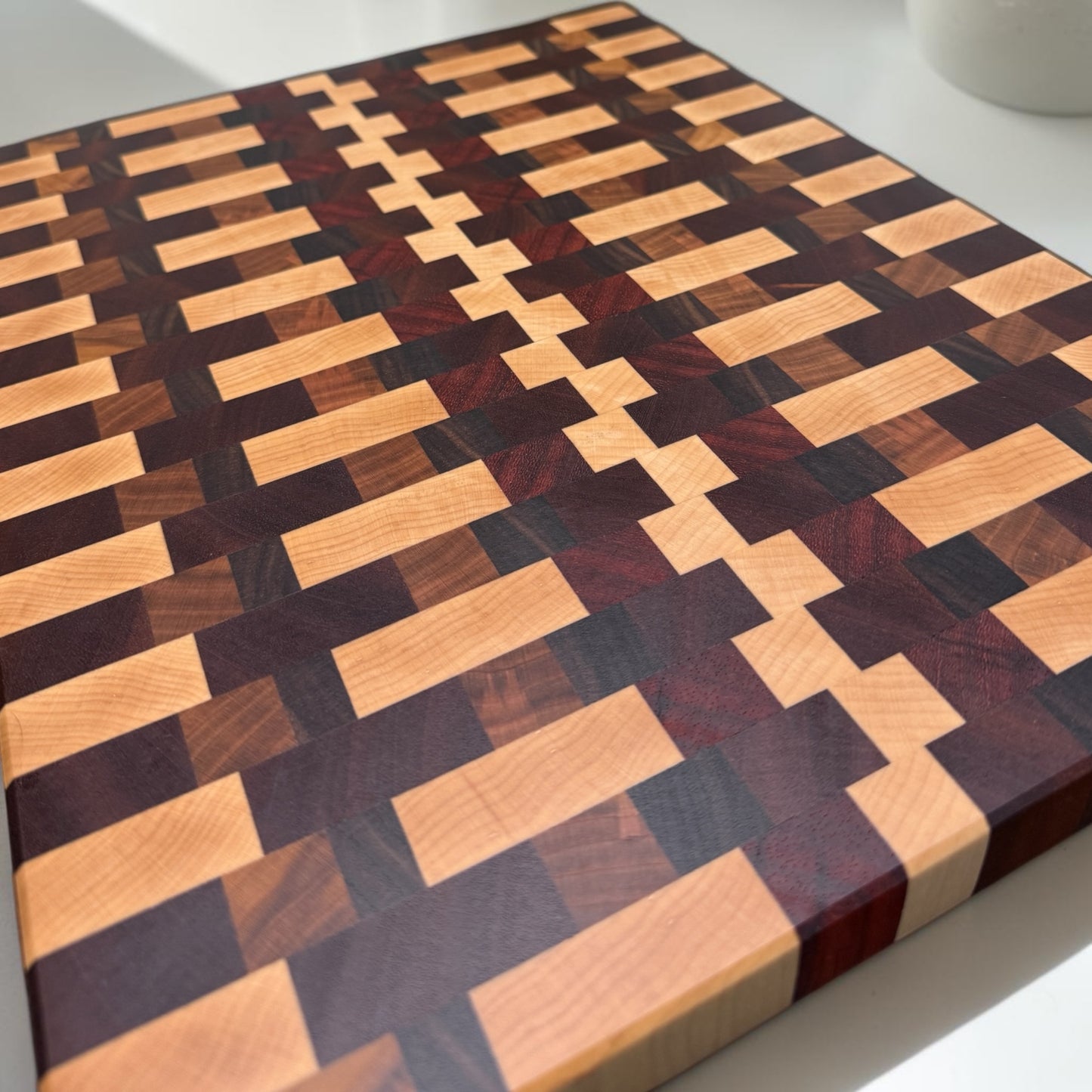Wooden cutting board with "Happy Together" engraved design by Covered Bridge Workshop, showing a smooth, light-colored surface.