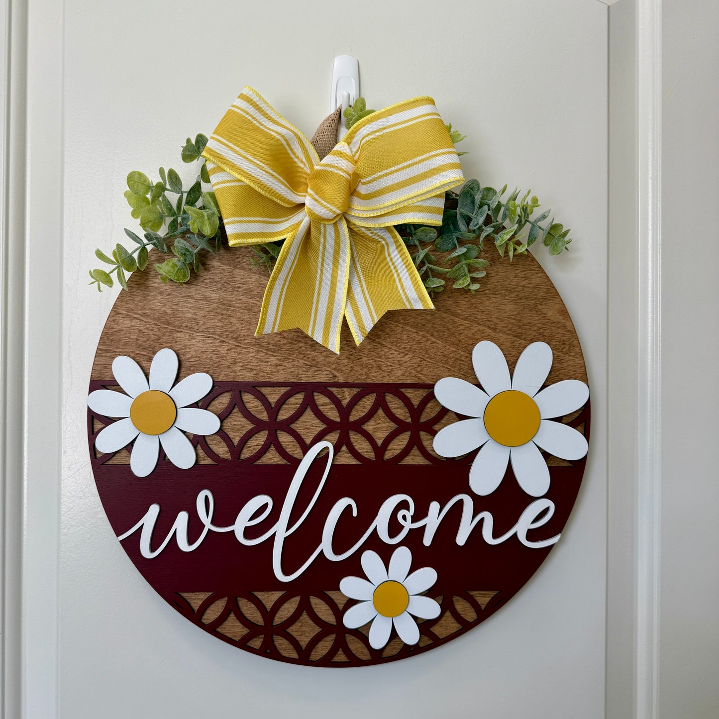 Decorative door hanger featuring a Welcome Daisy II design by Covered Bridge Workshop, ideal for front door or entryway decor.