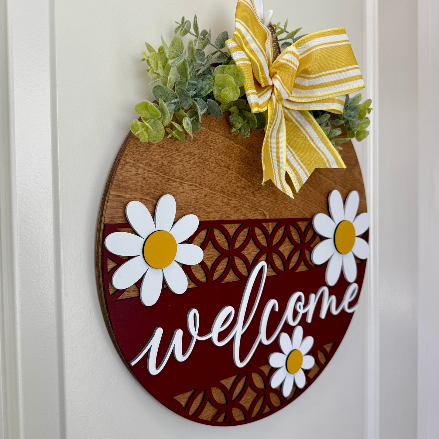 Decorative door hanger with a welcoming Daisy II floral design by Covered Bridge Workshop, hangs on a door for a charming greeting.